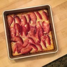 a pan filled with bacon sitting on top of a wooden table