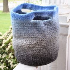 a crocheted bag sitting on top of a window sill