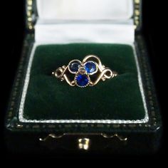 antique clover ring intricate scrollwork on shoulders of band detailed & vibrant synthetic sapphires  accent seed pearl center milgrain edge around stones yellow gold in tone - not marked, tested for 14k circa early 1900's condition: good + note below + wear to milgrain edge around one stone presents beautifully  measures approx. : size 6 3/4 feel free to ask and questions prior to purchase band may be resized, please consult your jewler item is vintage & in used condition - ring box not include 3 Leaf Clover, Diamond Dress Ring, Clover Ring, Baby Rings, Diamond Dress, Dress Rings, Seed Pearl, Pinky Ring, Cz Diamond