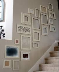 a staircase with pictures on the wall and stairs painted in different colors, including white