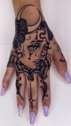 a woman's hand with tattoos on it