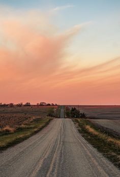 an empty dirt road in the middle of nowhere