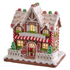 a christmas gingerbread house with lights and decorations