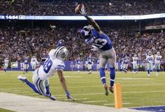 two football players jumping into the air during a game