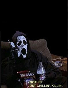 a person wearing a mask sitting on a couch with two sodas in front of them