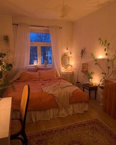 a bed room with a neatly made bed next to a desk and window at night