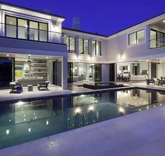 a large house with a swimming pool at night