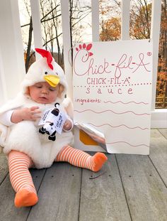 a baby in a chicken costume sitting on the porch next to a sign that says chick flex