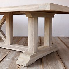 a wooden table sitting on top of a wooden floor