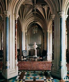 an ornate room with columns and a statue in the center