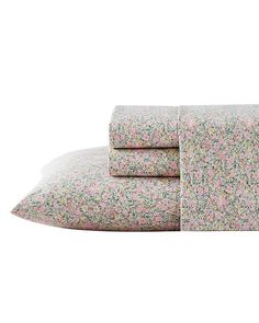 the pink and green floral sheet set is folded on top of each other