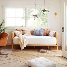 a living room filled with furniture and plants