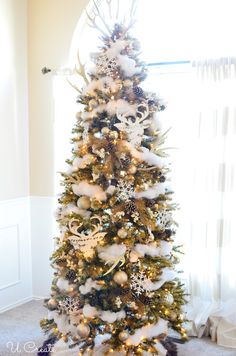 a decorated christmas tree with white and gold decorations