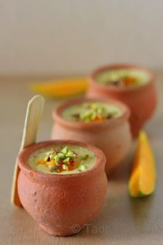 three small clay bowls filled with soup and garnishes