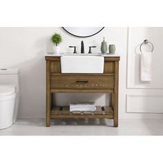 a white toilet sitting next to a wooden sink