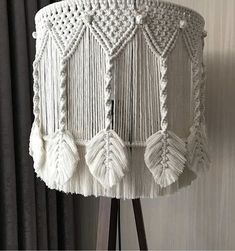 a lamp that has some tassels on it and is next to a curtain