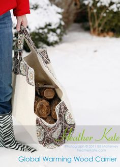 a woman carrying a bag full of logs in the snow with her legs crossed and boots on