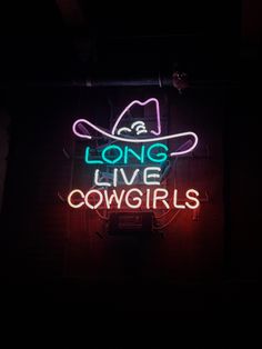 a neon sign that says long live cowgirls