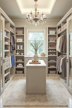 a walk in closet with chandelier and shelves