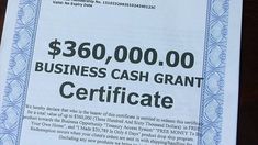 a business cash grant certificate is displayed on a table