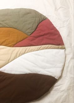 an image of a round bed with many colors on it