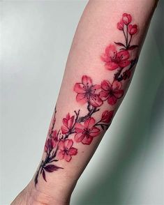 a woman's arm with pink flowers on it