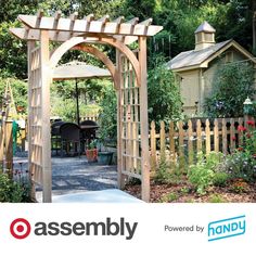 an outdoor garden with a wooden arbor and flowers