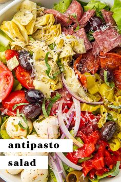 an image of a salad with tomatoes, olives and other vegetables