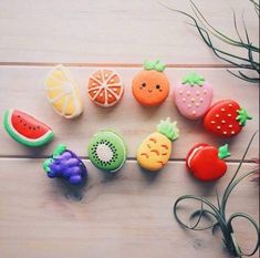 there are many different fruits and vegetables on the wooden table, including oranges, watermelon, kiwi, grapefruit, pineapple