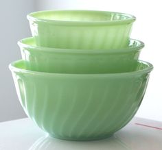 three green glass bowls stacked on top of each other