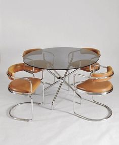 a glass table with four chairs around it