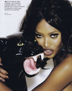 a woman with her mouth open holding a black cat