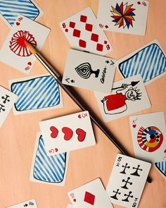 several playing cards and a brush on a table