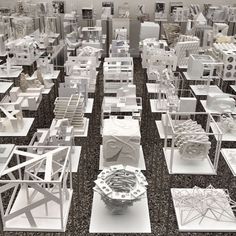 a large group of white sculptures sitting on top of a floor