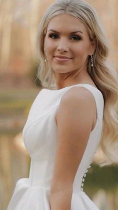 a woman with blonde hair wearing a white dress