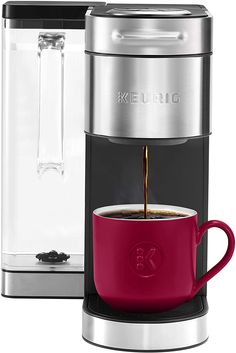 the keurig coffee maker is ready to be filled with liquid and served in a red mug