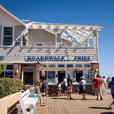 people are standing outside the boardwalk restaurant