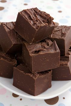 a white plate topped with chocolate pieces on top of a table