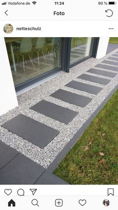 an image of a walkway made out of stones and gravel in front of a window