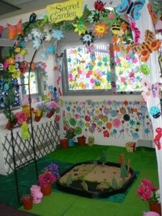 the room is decorated with many colorful flowers and paper butterflies on it's walls