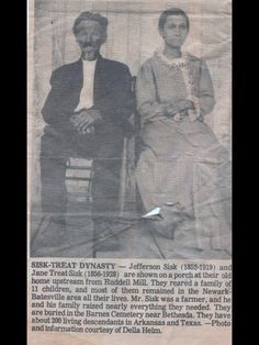 an old photo of two people sitting next to each other