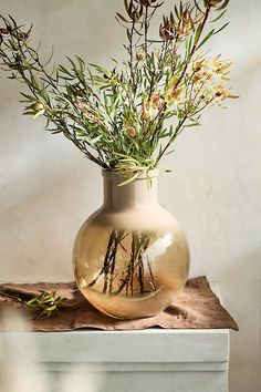 a vase filled with flowers on top of a wooden table