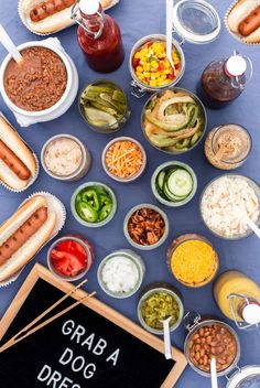 a table topped with lots of different types of food and condiments on top of it