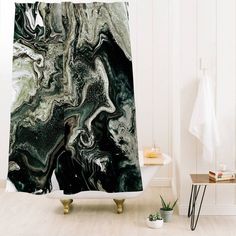 a shower curtain with an abstract design in black, white and green colors on it