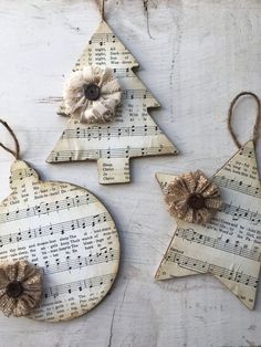 three wooden ornaments with sheet music on them