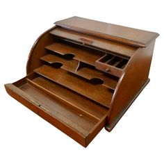 an old wooden desk organizer with drawers on the front and bottom shelf, open to reveal several compartments