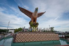 a large bird statue sitting on top of a fountain