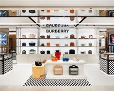 the inside of a burberry store with black and white checkered flooring