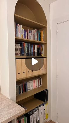 a book shelf filled with lots of books next to a wall full of other books