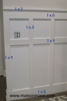 measurements for the door frame on a white cabinet with blue numbers in front of it